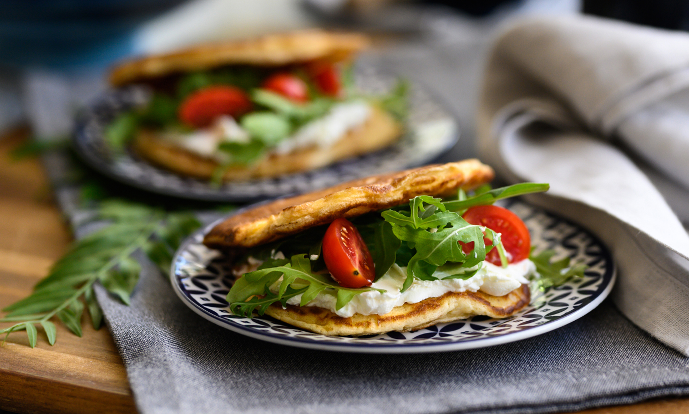 Stuffed savoury pancakes with mozzarella, smoked pork leg and cherry